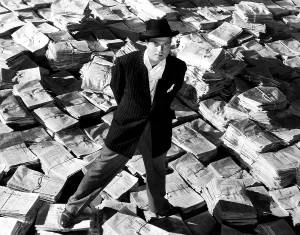 Osrs Prints: CITIZEN KANE, Orson Welles, 1941, astride stacks of newspaper