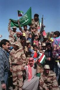 Images Dated 16th February 2011: Civilians and coalition military forces wave Kuwaiti