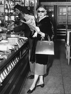 Luce Prints: Clare Booth Luce, at a newsstand at Paris Orly Airport before boarding a plane for Rome