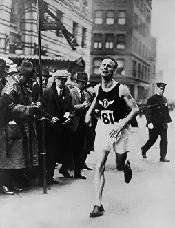 Informal Prints: Clarence Demar, running through an urban city commercial district