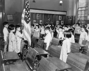 Chinese Americans Prints: Class with several Asian American children saluting the American flag while reciting the Pledge of Allegiance in New