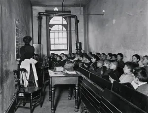 A class in the condemned Essex Market School on NYCs East Side with gas lighting. New Yorks exploding immigrant population caused crowding the public schools