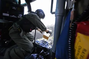 Hurricanes Prints: US Coast Guard helicopter drops a box of MRE's to locals near Utuado