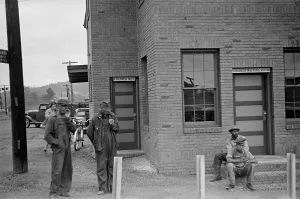 Public Accommodations Prints: Colored Waiting Room sign. Four African American men stand outside of the Manchester