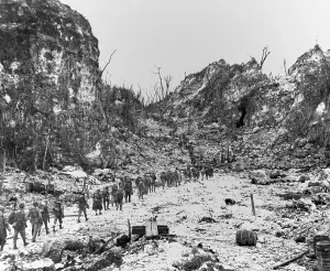 Lcgr1311 Prints: Column of Marines moves to the front lines through the rocky terrain of Peleliu Island