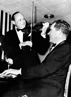 Comedian Jack Benny, with his violin, teams up with Vice President Richard Nixon at the Piano