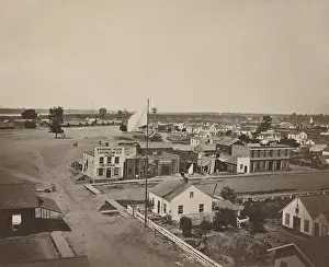 Port Prints: Commercial street in Cairo, Illinois, with Union military barracks in the distance, 1861