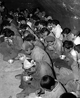 Disarmed Prints: Communist soldiers are fed in the POW stockade