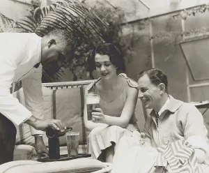 Commercial Prints: Couple served beer in a 1933 advertising photo for a brewer. (BSLOC_2013_8_155)