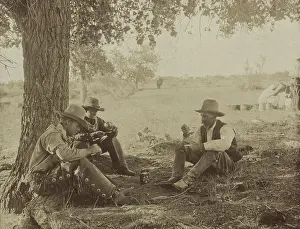 Sharing Prints: Three cowboys sitting under a tree