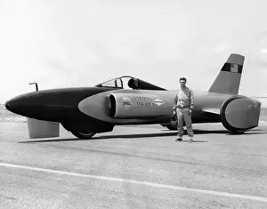 Logo Prints: Craig Breedlove stands beside his jet car Spirit of America on the Bonneville Salt Flats in Utah