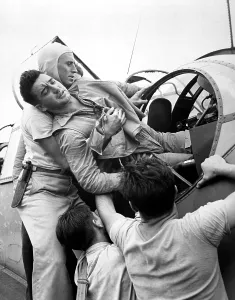 Lcgr1310 Prints: Crewmen lift a wounded pilot out of his Grumman TBF Avenger