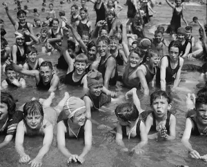 December Prints: Crowd of children, boys and girls, having fun at Washington, D.C. beach in 1923