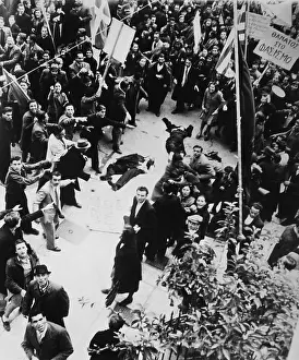 Lcgr1411 Prints: Crowd shouting and pointing towards a dead man and a woman lying in an Athens street