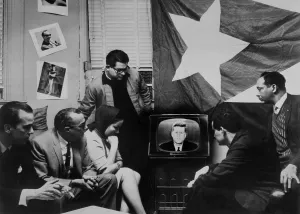 Blockade Prints: Cuban refugees gather watch President Kennedy announcing a quarantine of their home island during the Cuban Missile