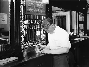 Customer Prints: Customer endorsing a check at Auburn, Maine savings bank in 1929 (BSLOC_2016_8_23)