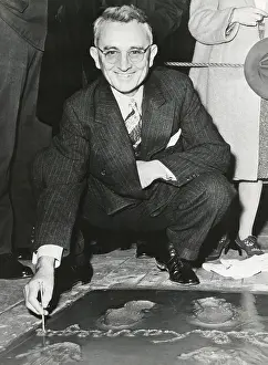 Lcgr1501 Prints: Dale Carnegie, signing his concrete slab at Grauman's Chinese Theatre
