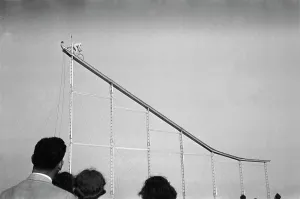 Show Business Prints: Daredevil preparing to dive into water from cycle down an elevated incline