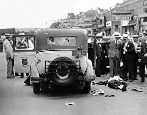 Taxi Prints: Detectives seek to identify the body of a slain gunman lying in the street beside a bullet ridden taxi