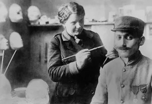 Head And Shoulder Prints: Disfigured WW1 Veteran's mask gets finishing touches by sculptor Anna Ladd. 1918