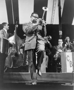 Dizzy Prints: Dizzy Gillespie (1917-1993) playing horn on stage in 1957