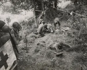 Explosives Prints: Doctors and medics giving first aid to a combat engineer injured by a land mine