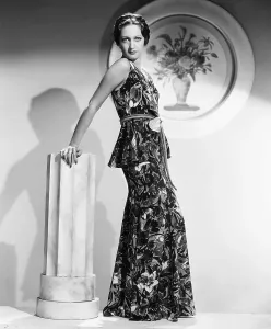 Lamour Prints: Dorothy Lamour, modeling a crepe floral evening frock with a leather belt, 1936