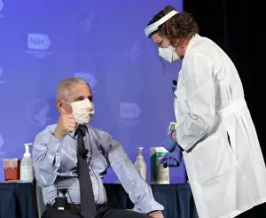 Shot Prints: Dr. Anthony Fauci, gives the thumbs up sign after publicly receiving the Moderna COVID-19 vaccine