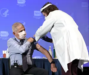 Shot Prints: Dr. Anthony Fauci, rolls up his sleeve to publicly receive the Moderna COVID-19 vaccine