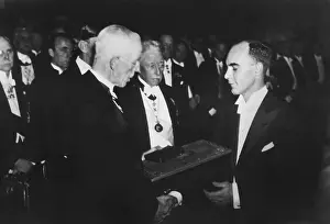 Sweden Prints: Dr. Carl Anderson, received the 1931 Nobel Prize in Physics from King Gustav of Sweden