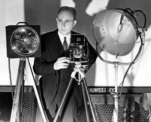 Harold Prints: Dr. Harold Edgarton, of M.I.T. stands behind his camera that boasts ultra-speed photography
