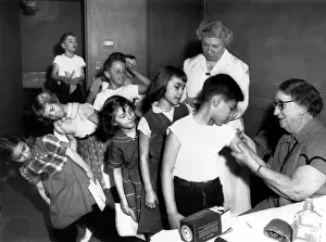 Doctor Prints: Dr. Nelle Reed gives vaccinations to Michigan city grammar school