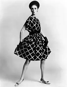 Pauline Prints: Dress by Pauline Trigere. Short and full skirted dress with a loose draped bodice