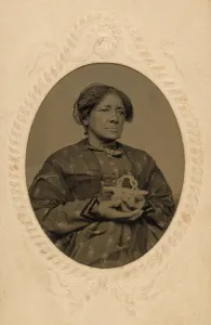 Dignity Prints: Well dressed middle aged, African American women holding a basket in the Post Civil War era