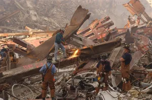 9 11 Prints: Dwarfed by the debris from the World Trade Center metal workers cut though the rubble pile in a futile search for
