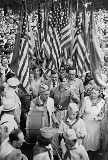 Earl Prints: Earl Browder surrounded by people at a Communist Party rally. Chicago, Jan. 4, 1947