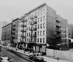 Street Scenes Prints: East Harlem street and large tenement apartment building at 311 East 100th Street in New York City