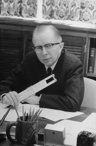 December Prints: Economist Paul MacCraken with a slide rule