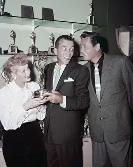 Celebrities Prints: Ed Sullivan (center) admiring the trophy shelf of Lucille Ball and Desi Arnaz