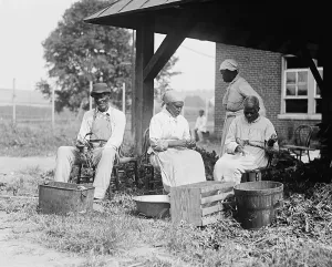 December Prints: Elderly African Americans who were once slaves work together in a rural setting in 1920