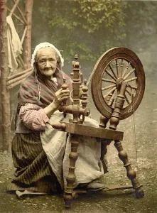 Costumes Prints: Elderly Irish Spinner working outdoors at her spinning wheel in the late 19th century