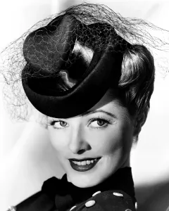 Eleanor Prints: Eleanor Parker, modeling a felt hat with black satin trim, October 1943