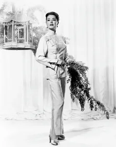 Parker Prints: Eleanor Parker, modeling lime-green brocade lounging pajamas, 1957