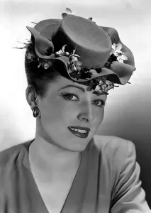 Eleanor Prints: ELEANOR PARKER, wearing a flat-crowned, double-brimmed hat nestled with violets, 1944