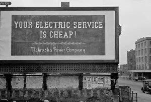 Images Dated 10th June 2013: Your Electric Service is Cheap reads a 1930s billboard