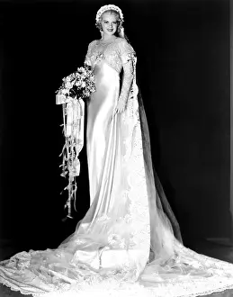 Bridal Bouquet Prints: ELINOR NORTON, Claire Trevor, in a white satin wedding gown by Rene Hubert