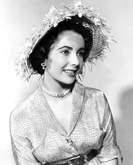 Jsx 73 Prints: Elizabeth Taylor, modeling a straw hat trimmed with light-blue sweet peas