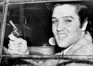 Zast Prints: Elvis Presley holding the toy pistol he claimed he used in settling dispute with Marine Private Hershel Nixon
