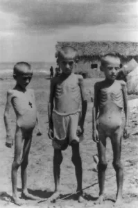Starvation Prints: Three emaciated Polish refugee children who have escaped to Iran during World War 2