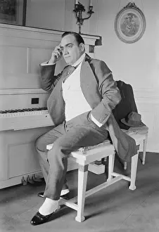 Caruso Prints: Enrico Caruso (1873-1921) seated at the piano in his New York apartment. Ca. 1915